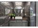 Modern bathroom featuring black marble, a vanity with a vessel sink and round mirrors at 409 Englewood Dr, Chapel Hill, NC 27514