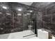 Modern bathroom featuring black marble, a glass shower with gold fixtures and a luxurious feel at 409 Englewood Dr, Chapel Hill, NC 27514