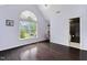 An airy bedroom features a large window, hardwood floors, and an adjacent bathroom at 409 Englewood Dr, Chapel Hill, NC 27514
