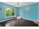 Comfortable bedroom with dark hardwood floors, bright natural light, and blue painted walls at 409 Englewood Dr, Chapel Hill, NC 27514