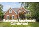 Traditional brick home with a well-manicured lawn and mature trees at 409 Englewood Dr, Chapel Hill, NC 27514