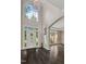 Grand two-story foyer with high ceilings, large windows, dark hardwood floors, and elegant chandelier at 409 Englewood Dr, Chapel Hill, NC 27514