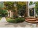 Close-up of the front door showcasing the entryway, landscaping, and brick facade at 409 Englewood Dr, Chapel Hill, NC 27514