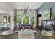 Stylish living room featuring a fireplace, hardwood floors, large windows, and sophisticated decor at 409 Englewood Dr, Chapel Hill, NC 27514