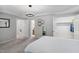 Spacious main bedroom with tray ceiling, carpet floors, and convenient ensuite bathroom and closet at 409 Englewood Dr, Chapel Hill, NC 27514