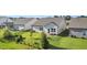 Expansive backyard showcasing a well-maintained lawn, landscaping, and a cozy patio area at 4102 Catfish Way, Durham, NC 27703