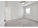 A well-lit, carpeted bedroom with one window and a ceiling fan at 4102 Catfish Way, Durham, NC 27703