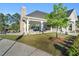 Community clubhouse with covered seating, a stone fireplace, and well-manicured landscaping at 4102 Catfish Way, Durham, NC 27703