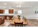 A dining room featuring a wood dining table, chandelier, and wood floors in a well-lit home at 4102 Catfish Way, Durham, NC 27703