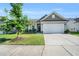 Charming single-story home featuring a well-manicured lawn, two car garage, and classic architectural details at 4102 Catfish Way, Durham, NC 27703