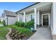 Inviting front entrance with manicured landscaping, featuring a dark wood door and ADT security system at 4102 Catfish Way, Durham, NC 27703