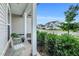 Relaxing covered front porch with seating area, offering a charming view of the neighborhood street at 4102 Catfish Way, Durham, NC 27703