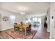 Open-concept living space featuring a dining area with wood floors and a comfortable sitting area at 4102 Catfish Way, Durham, NC 27703