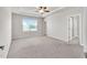 A spacious main bedroom with a ceiling fan, tray ceiling, and natural light at 4102 Catfish Way, Durham, NC 27703