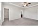A spacious main bedroom with a ceiling fan, tray ceiling, and natural light at 4102 Catfish Way, Durham, NC 27703