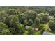 Lush, green landscape surrounding a charming home with a convenient carport in an aerial view at 416 Forrest St, Hillsborough, NC 27278