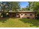 The rear exterior of the home, with a relaxing back porch and lush green lawn at 416 Forrest St, Hillsborough, NC 27278