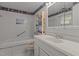 Bathroom featuring white tiled walls and a white vanity with a large mirror at 416 Forrest St, Hillsborough, NC 27278