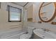 Full bathroom with a shower/tub combo, and a sink with an oval wood-trimmed mirror at 416 Forrest St, Hillsborough, NC 27278