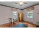 Charming bedroom features hardwood floors, decorative trim, natural light from two windows and simple furniture at 416 Forrest St, Hillsborough, NC 27278