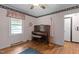 Bedroom featuring wood floors, one window, and furnished with piano and bench at 416 Forrest St, Hillsborough, NC 27278