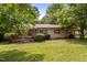 Charming single-story home with a well-maintained front yard and mature landscaping at 416 Forrest St, Hillsborough, NC 27278