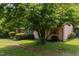 A charming single-story home with a lush, green front yard and a large tree providing ample shade at 416 Forrest St, Hillsborough, NC 27278