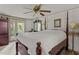 Bright main bedroom with white walls, ceiling fan, sitting area, and access to the exterior at 416 Forrest St, Hillsborough, NC 27278