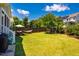Spacious backyard with manicured lawn, mature trees, hammock, swing set, and room for outdoor relaxation and play at 42 Juneberry Dr, Chapel Hill, NC 27516