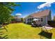 Spacious backyard with a manicured lawn, a patio for entertaining, and privacy fencing at 42 Juneberry Dr, Chapel Hill, NC 27516