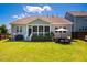 Well-maintained backyard featuring lush grass, a patio seating area, and mature trees at 42 Juneberry Dr, Chapel Hill, NC 27516