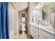 Bright bathroom featuring a double vanity with white cabinets, a toilet, and a shower/tub combination at 42 Juneberry Dr, Chapel Hill, NC 27516