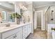 Bathroom with double vanity sinks, white cabinets, and tile flooring at 42 Juneberry Dr, Chapel Hill, NC 27516