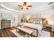 Stylishly decorated bedroom with tray ceilings, a cozy bed, and wood flooring at 42 Juneberry Dr, Chapel Hill, NC 27516