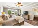 A bedroom with large windows offering views of the backyard and a comfortable seating area at 42 Juneberry Dr, Chapel Hill, NC 27516