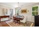 Elegant dining room with hardwood floors, classic furnishings, and ample natural light at 42 Juneberry Dr, Chapel Hill, NC 27516