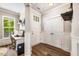 Functional entryway with hardwood floors, closet and adjacent office space with natural light at 42 Juneberry Dr, Chapel Hill, NC 27516