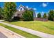 Charming two-story home featuring manicured landscaping and a green lawn at 42 Juneberry Dr, Chapel Hill, NC 27516