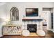 Beautiful fireplace with decorative tile work, flanked by a side table at 42 Juneberry Dr, Chapel Hill, NC 27516