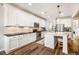 Well-lit kitchen boasting stainless steel appliances, a breakfast bar, and hardwood flooring at 42 Juneberry Dr, Chapel Hill, NC 27516