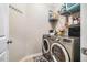 Modern laundry room with stainless steel washer and dryer, plus storage shelves at 42 Juneberry Dr, Chapel Hill, NC 27516