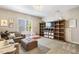 Inviting living room with cozy seating, custom bookshelves, and a view to the outdoors at 42 Juneberry Dr, Chapel Hill, NC 27516