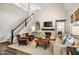 Bright living room boasting high ceilings, a fireplace, and an open staircase at 42 Juneberry Dr, Chapel Hill, NC 27516