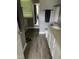 Bathroom with wood-look flooring, gray walls and a towel rack above the toilet at 433 Turnberry Dr, Mebane, NC 27302