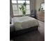Inviting bedroom with a large bed, a tall plant, and a dresser near the window at 433 Turnberry Dr, Mebane, NC 27302