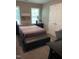 Well-lit bedroom featuring a large bed, a landscape painting, and two windows at 433 Turnberry Dr, Mebane, NC 27302