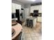 Eat-in kitchen featuring white cabinets, a center island, and stainless steel appliances at 433 Turnberry Dr, Mebane, NC 27302