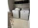 Clean laundry room features a modern washer, dryer and tiled floors at 433 Turnberry Dr, Mebane, NC 27302