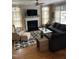 Cozy living room with a fireplace, neutral decor, and a large sectional sofa at 433 Turnberry Dr, Mebane, NC 27302