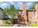 Brick townhome featuring a chimney, exterior storage closet, and sidewalk leading to the front door at 435 Summerwalk Cir # 435, Chapel Hill, NC 27517